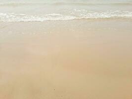 wave of sea beach on sandy shore photo