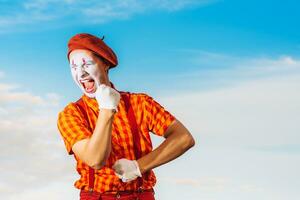 Mime shows pantomime against the blue sky photo