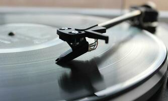 Turntable head on black vinyl disc top view detailed stock photo