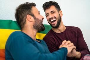 Happy gay couple having tender moments in bedroom - Homosexual love relationship and gender equality concept photo