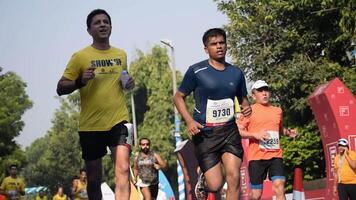 New Delhi, India - October 15 2023 - Vedanta Delhi Half Marathon race after covid in which marathon participants about to cross the finish line, Delhi Half Marathon 2023 video