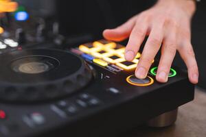 a DJ plays music on a controller at a party photo