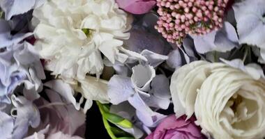 Rotating spring summer floral pastel arrangement in the background close up. Celebrating Mother's Day, International Women's Day March 8. Flowers gardenia, rose, peony video