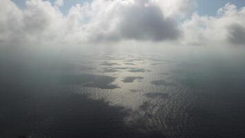 Aerial view. The drone flies over foggy and fluffy clouds. Blue sky sun and sea fog. Abstract aerial nature summer ocean sunset sea and sky background. Vacation, vacation and holiday concept video