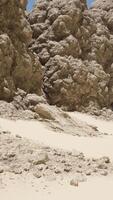 A sandy beach covered in lots of rocks video