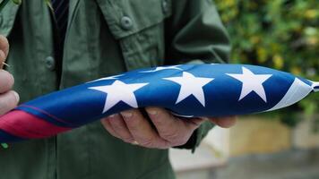 Folded Flag In Commemoration Of American Fallen Held In Hand video