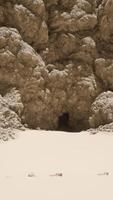 A group of rocks on a sandy beach video