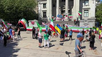 uprising of Iranian people in Canada in Vancouver people flags took to demonstration In defense of human rights against war against terrorism demanding change in power to overthrow ruler of dictator video