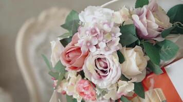 Floral background for a bride on a wedding day. . Close up of a soft and beautiful bouquet with opened buds and green leaves. video