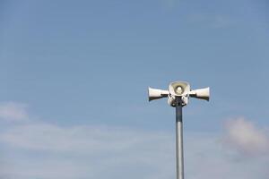 Horn speaker in the park with blue sky background photo