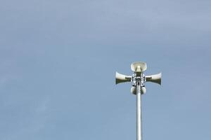 Horn speaker in the park with blue sky background. photo