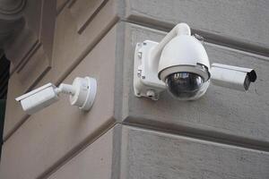 Three CCTV security camera operating on a building outdoor photo