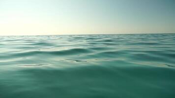 Sea water surface. Low angle view from kayak, camera flies over clear sea water. Nobody. Holiday recreation concept. Abstract nautical summer ocean nature. Slow motion. Close up. Vertical video