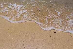 Sea surf on the beach with sand. photo