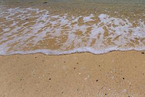 Sea surf on the beach with sand. photo