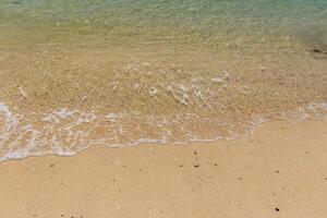 Sea surf on the beach with sand. photo