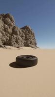 A tire sitting in the middle of a desert video