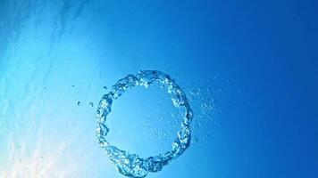 Ring bubbles move underwater in clear blue sea video