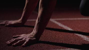 Closeup View Of Muscular Runner Hands On Floor Of Sprinter Lane, Man Standing In Low Start Position video