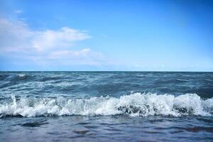 Beach with waves from the sea. Blue water in the beautiful ocean. photo