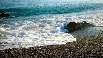 Foamy waves of a sea blue water rocks of the shore in Antibes, France photo