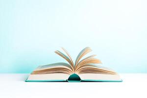 Open book with blue cover on a white and blue background photo