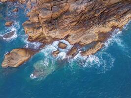 Aerial drone top view of beautiful waves crashing on the rocky island coast, ocean waves and fantastic. Ocean in Vietnam. photo