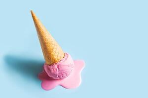 Pink ice cream melting and spilling photo