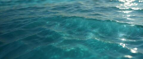 Beautiful turquoise blue ocean water surface with light reflections and highlights Texture of water close-up macro. photo