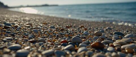 Pebbles on the beach with blurred sea water on a background. photo