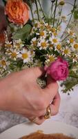 Woman Arranging Bouquet of Wildflowers and Roses for Table Decoration video