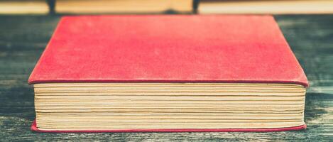 Old book in the red obnozhka. Symbol of knowledge and learning. photo