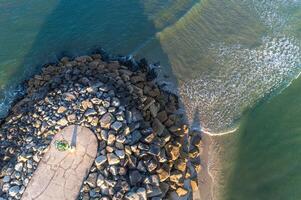 drone aerial view of a harbor breakwater end photo