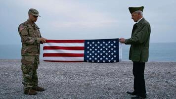 Soldier And Veteran Folding The USA Flag Together video