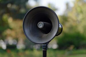 Public address system speaker mounted on pole announcing outdoors photo