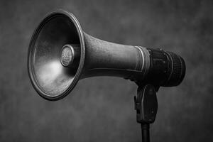 Black and White Megaphone with a Lens on a Stand photo