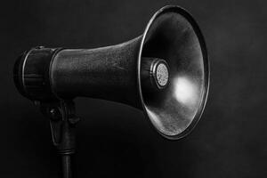 Black Megaphone with a Textured Surface on a Black Background photo