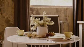 Table layout with yellow cups and plates ready for breakfast. video