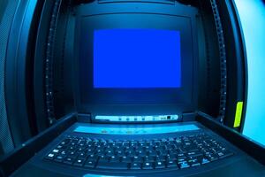 A computer with a blue screen sitting on a table photo