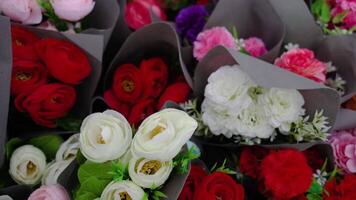 Stylish colourful rose bouquets in paper in flower store video