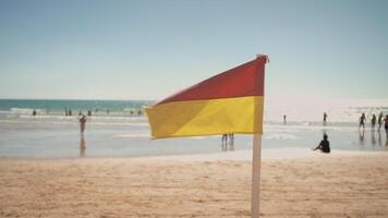 Red and Yellow Flag Symbolizing Safe Swimming at Portuguese Beach video