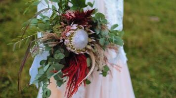 Wedding bouquet in bride hands. Bride bouquet in the hands of the bride video