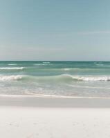 A beach with waves and a blue sky photo