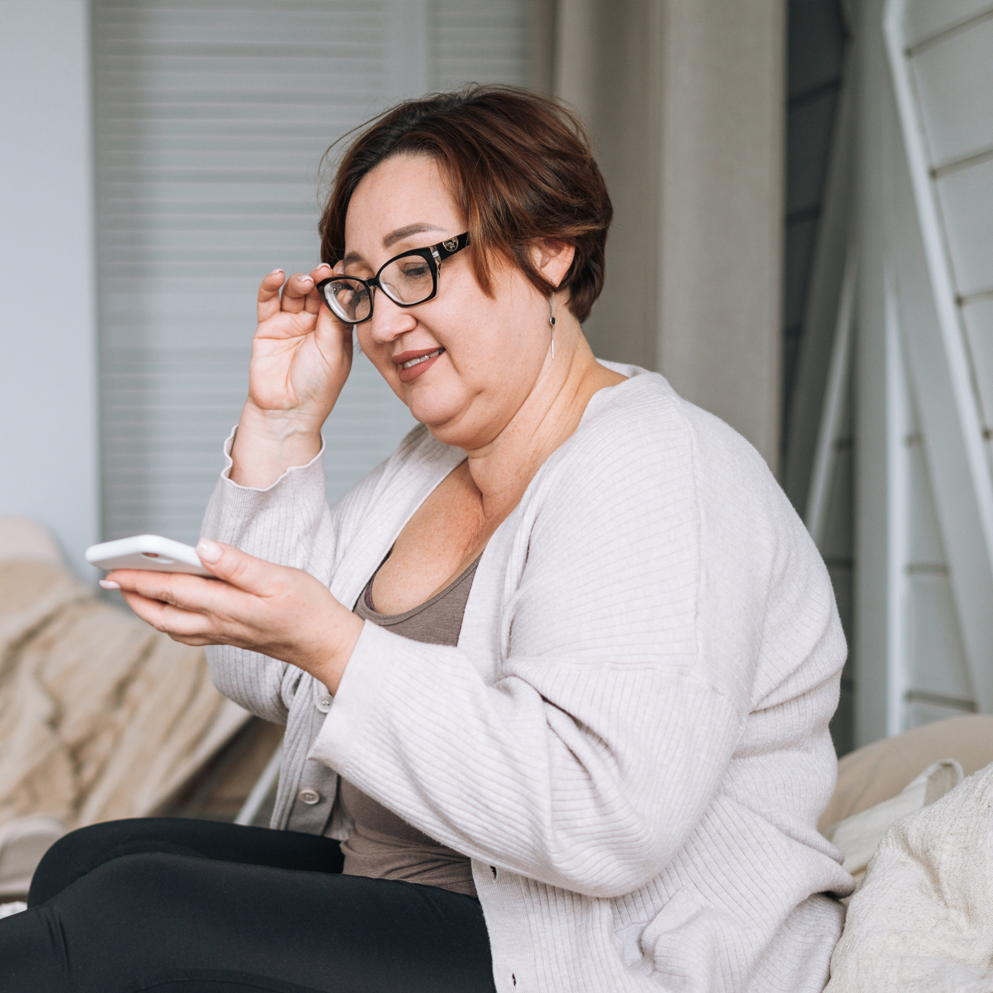 Woman looking at phone on couch