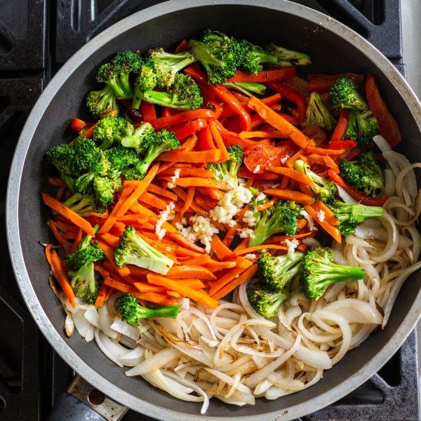 all the veggies frying in a skillet