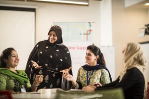 Group of women learning and teaching in classroom, developing their educational leadership and performance management