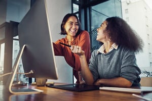 Collaboration, computer and business women in the office while working on a corporate project together. 