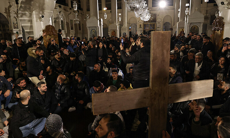 Christian youths stage a sit-in inside the Mariamite Church in Damascus early on Dec 24, 2024. — AFP