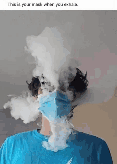 a person wearing a face mask with smoke coming out of it .