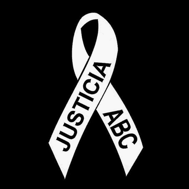 a white ribbon with the words justicia abc on it on a black background .